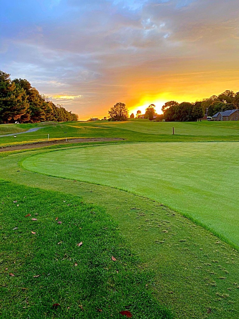 view of the golf course at sunset